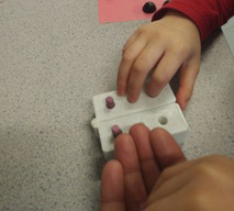 Braille swing cell being manipulated by a child